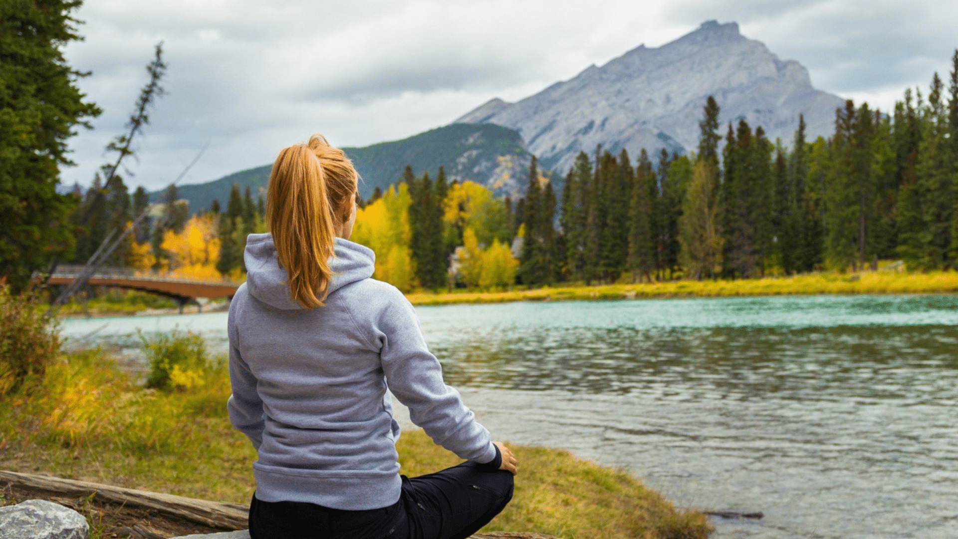 Woman meditating by a lake